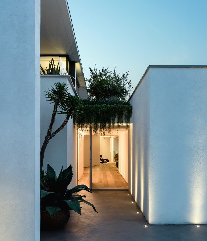 An enclosed passage and lit threshold at Villa Aghe.