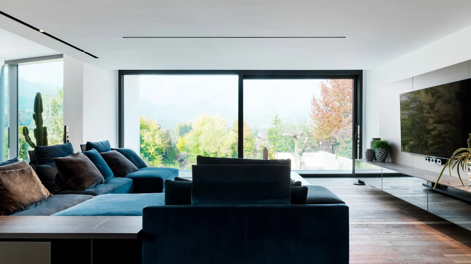 A broad living-room view gives the opening a furnished foreground.