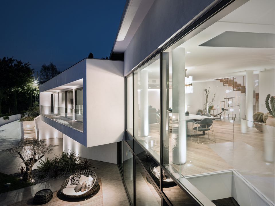 Villa Aghe seen from outside after dark; a documented project view.