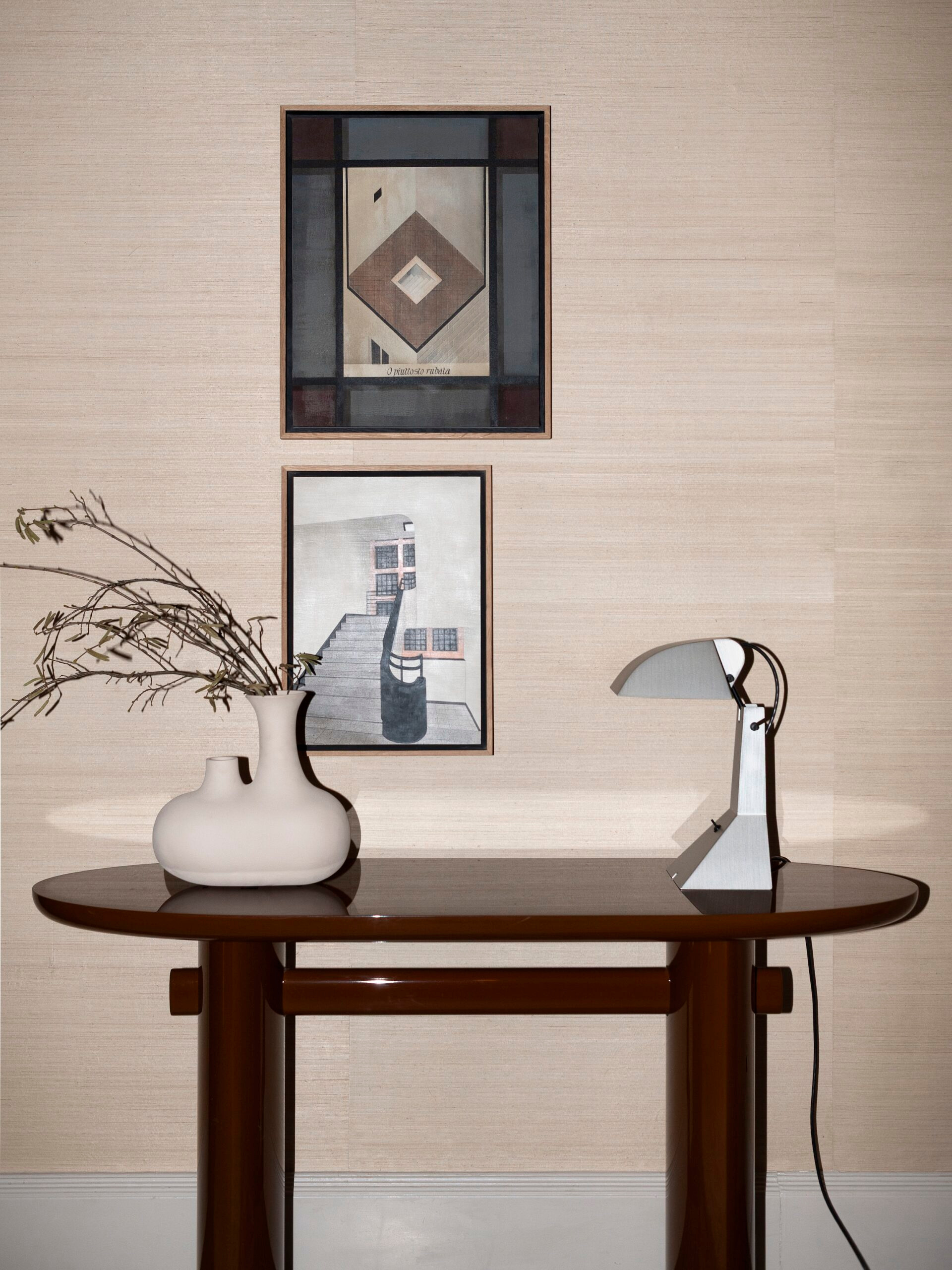 Console, framed works and local light in the same showroom project.