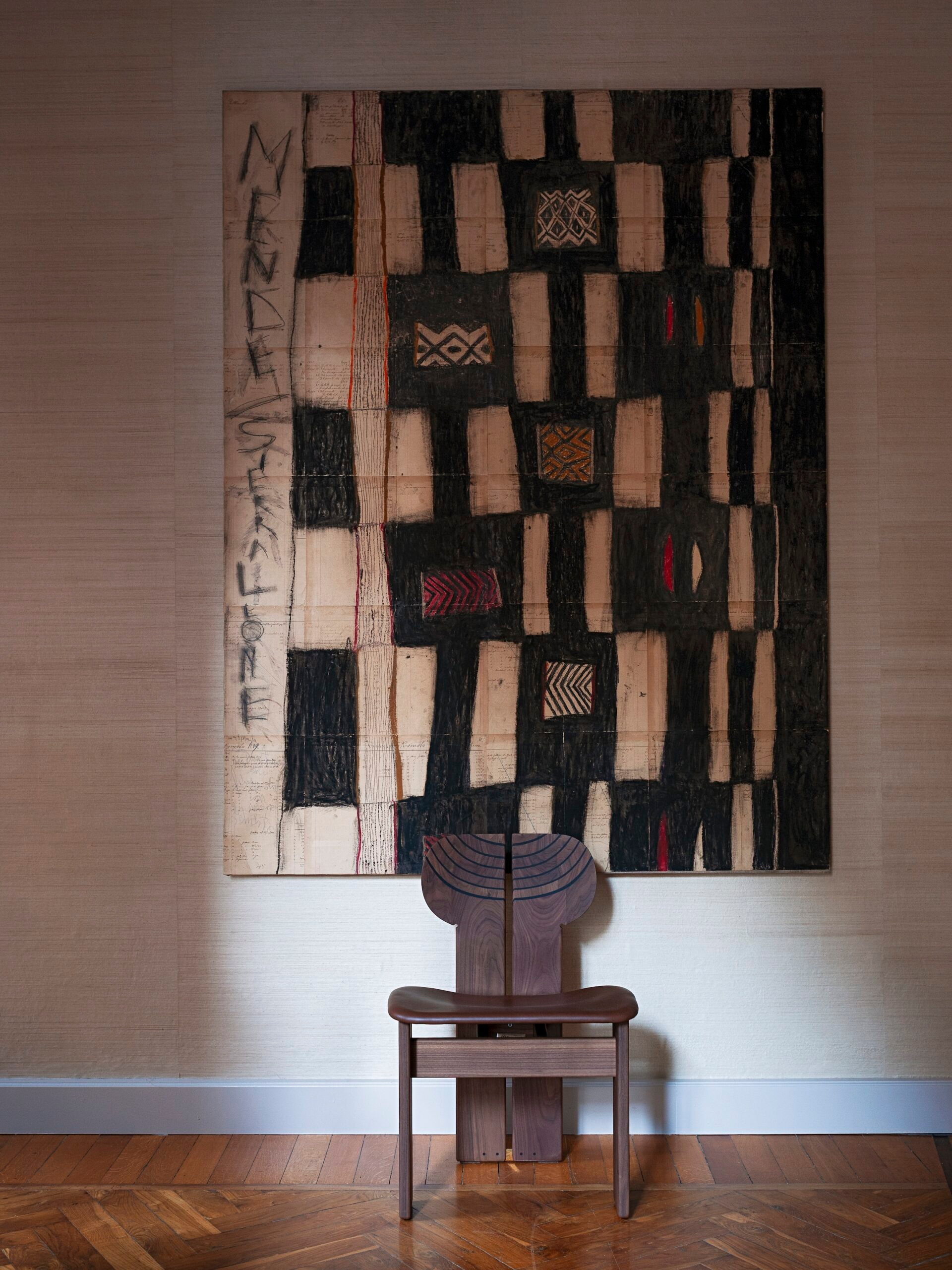 A chair and wall-hung work in the documented showroom sequence.