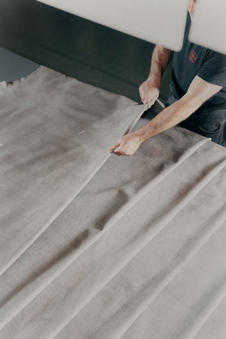 Marking and handling a hide on the production table.