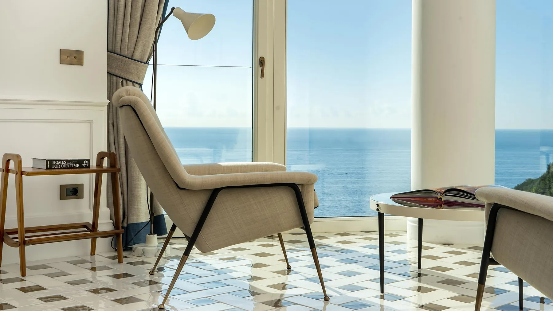 A seating arrangement beside the sea in TATO’s official project imagery.