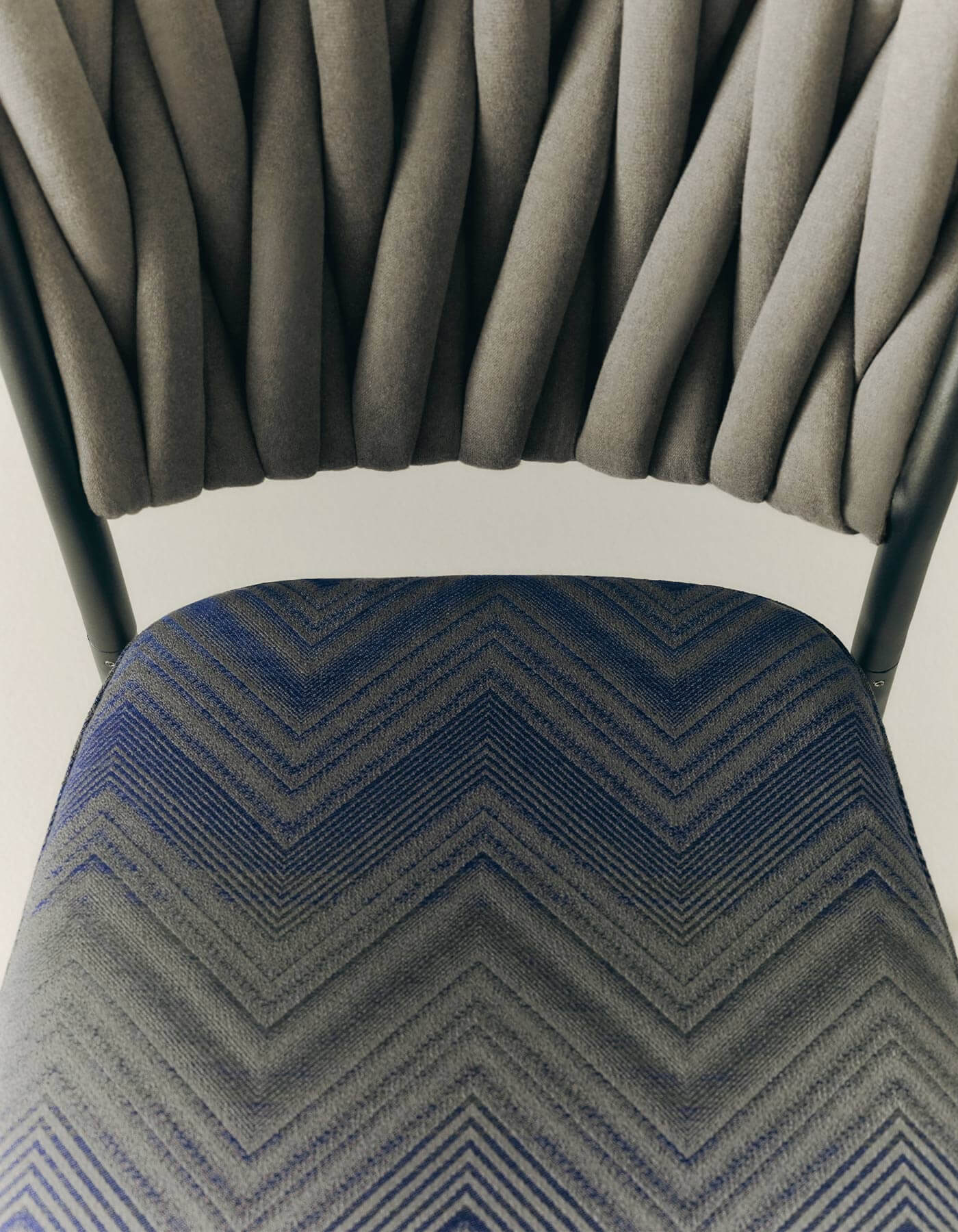 A nearer view of the chair’s woven surface and cushion.