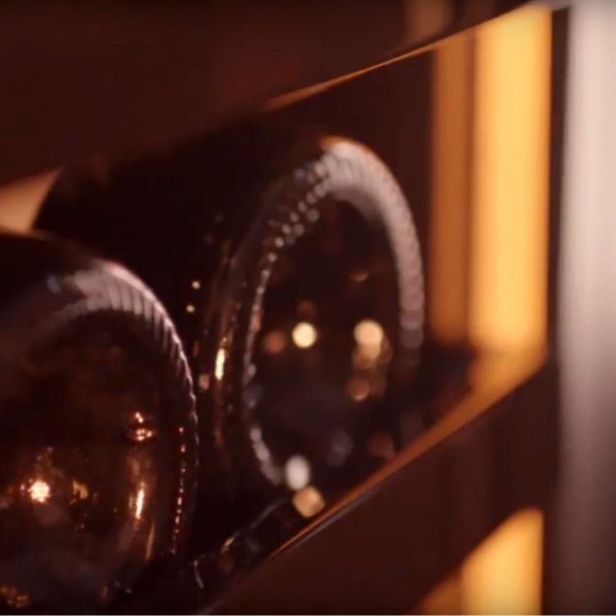 The lighting around stored bottles in the official product imagery.