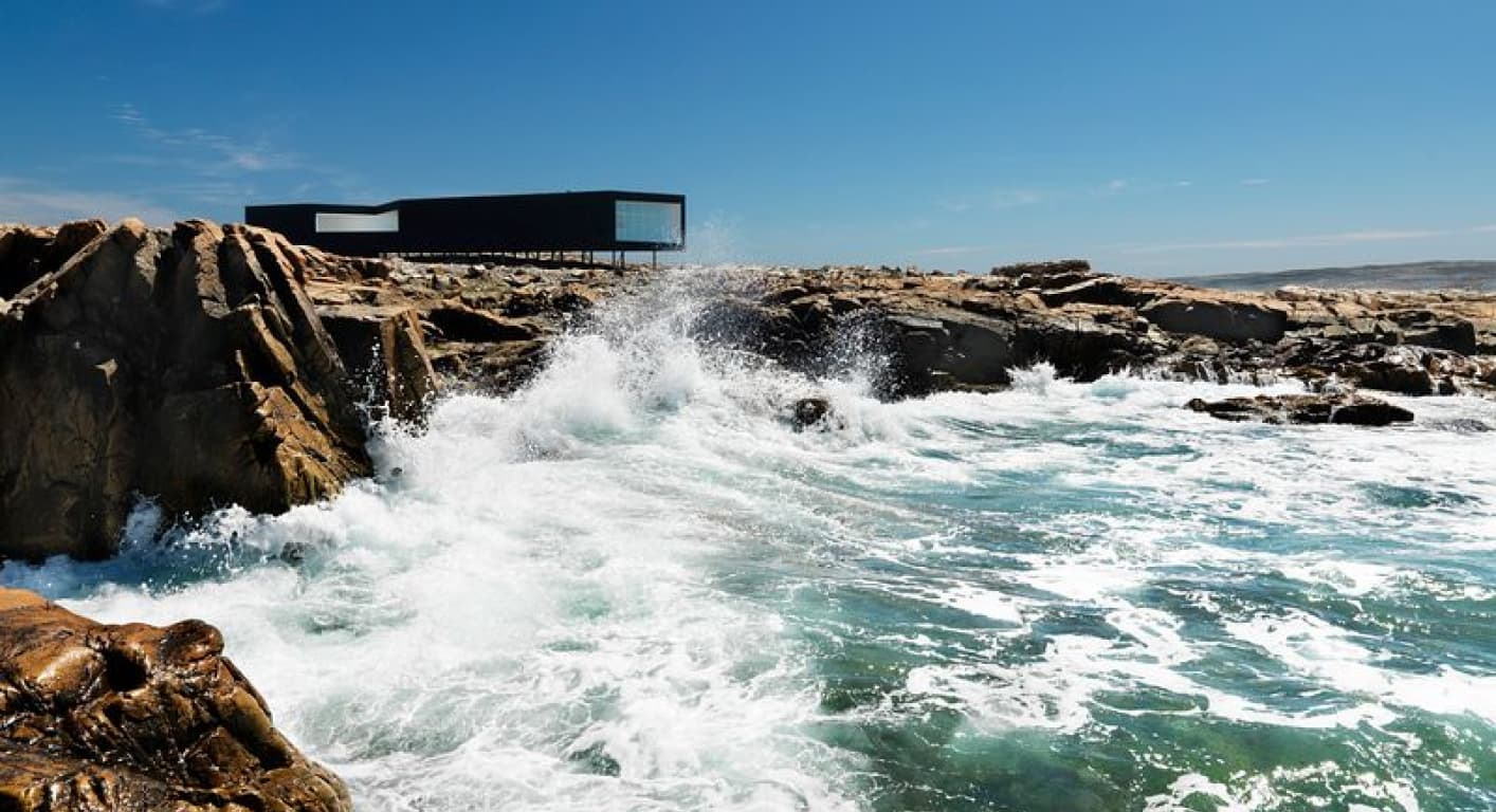 An artist’s studio beside the coast in the property’s published island sequence.