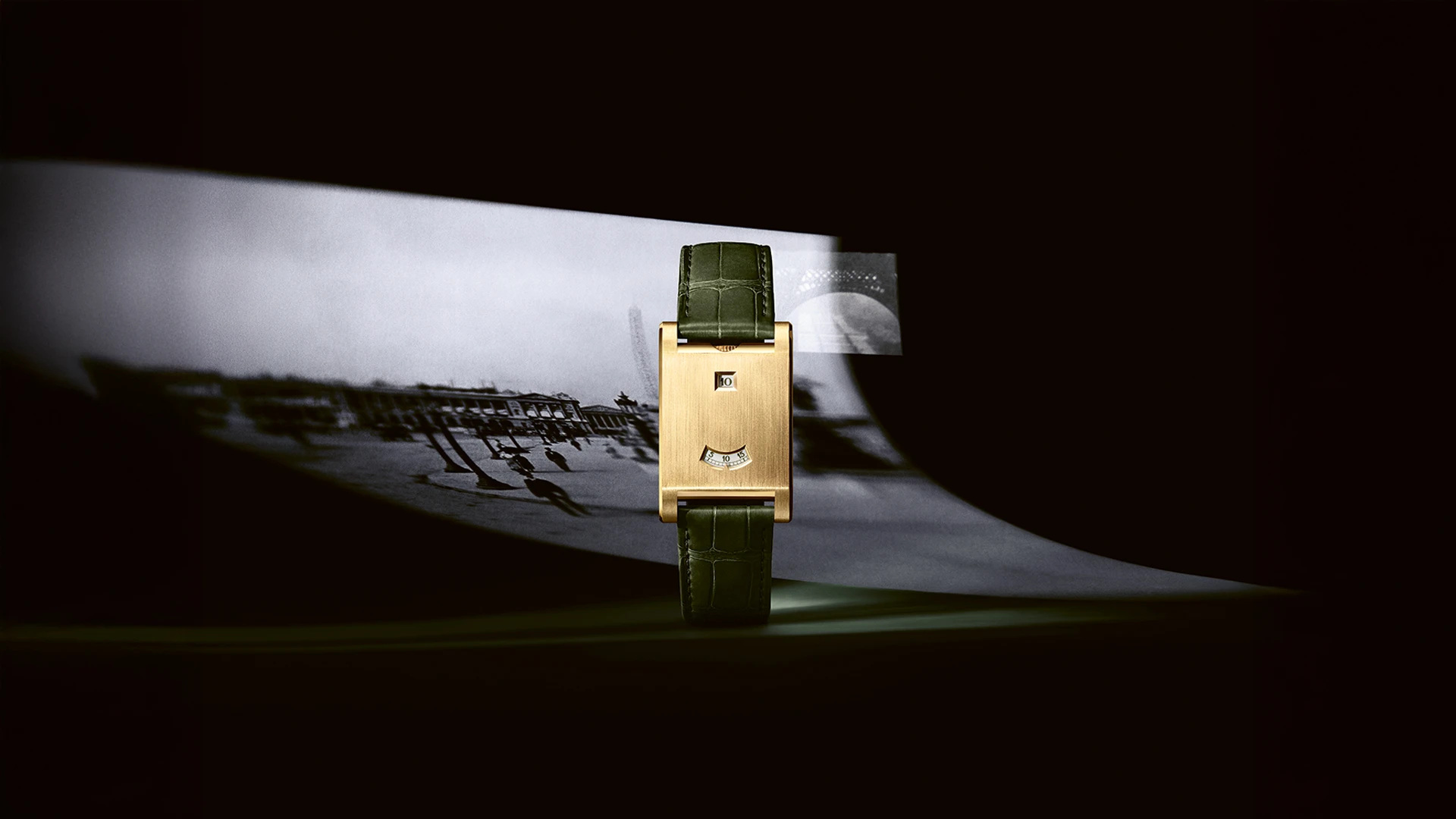 The yellow-gold Tank à Guichets in Cartier’s 2025 launch imagery, with green strap styling; a dated launch configuration.