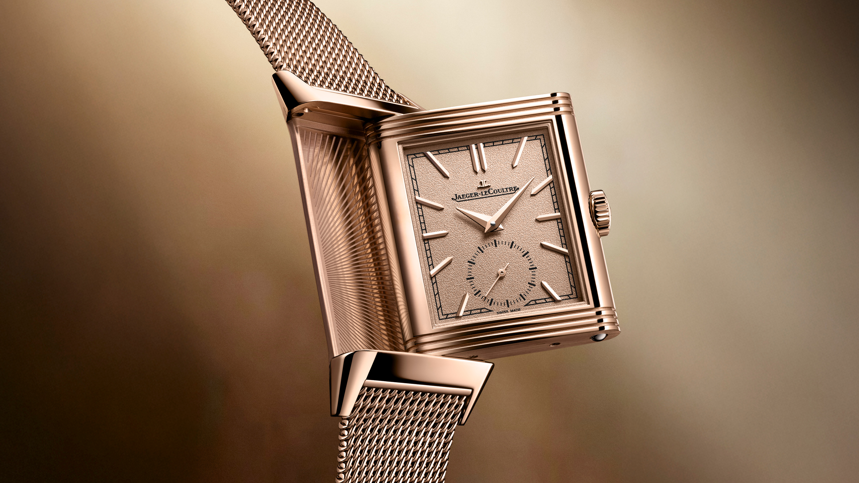 The grained dial, case edges and woven-looking bracelet in an official Q713216J close view.
