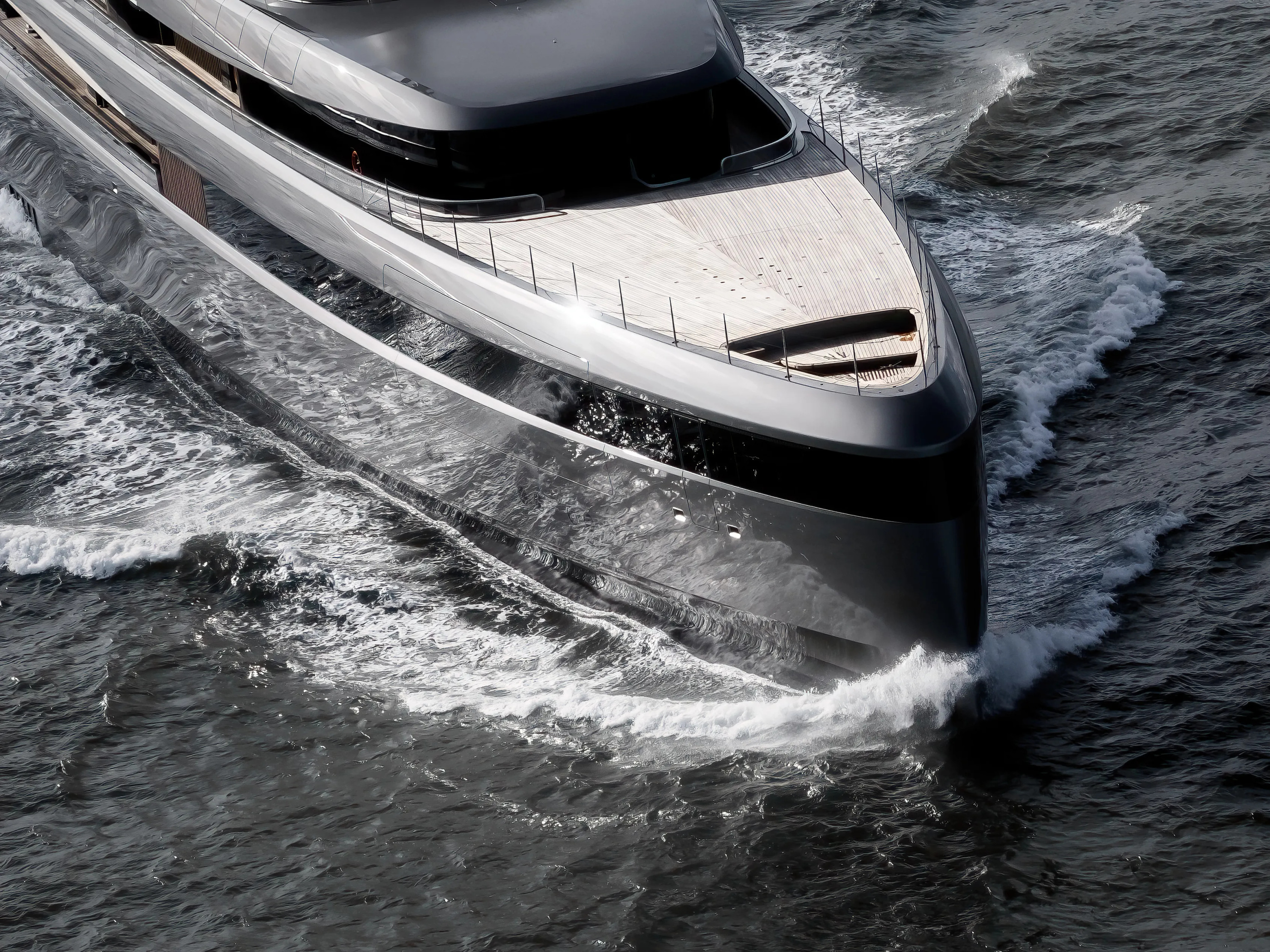 The curved glazing and foredeck seen from above the bow of Obsidian.