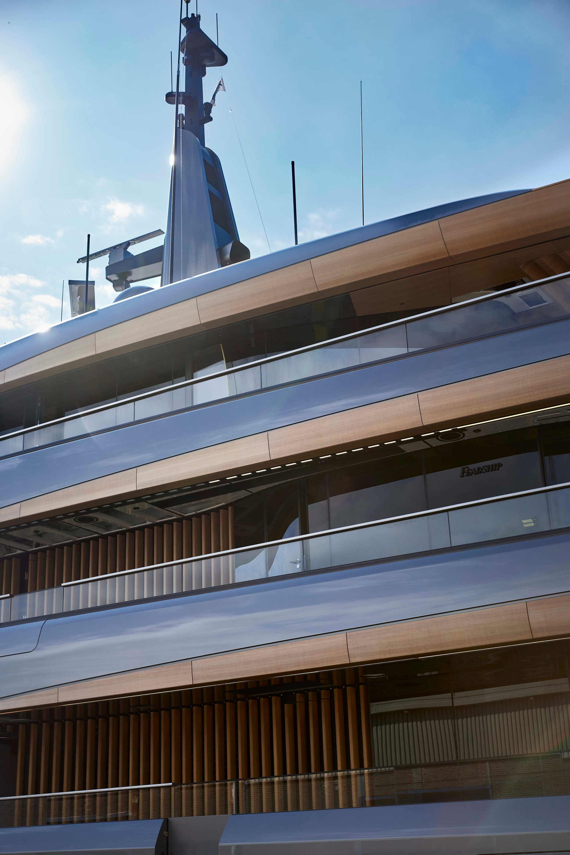 Vertical layers of glazing and overhangs on Obsidian, photographed close to the hull.