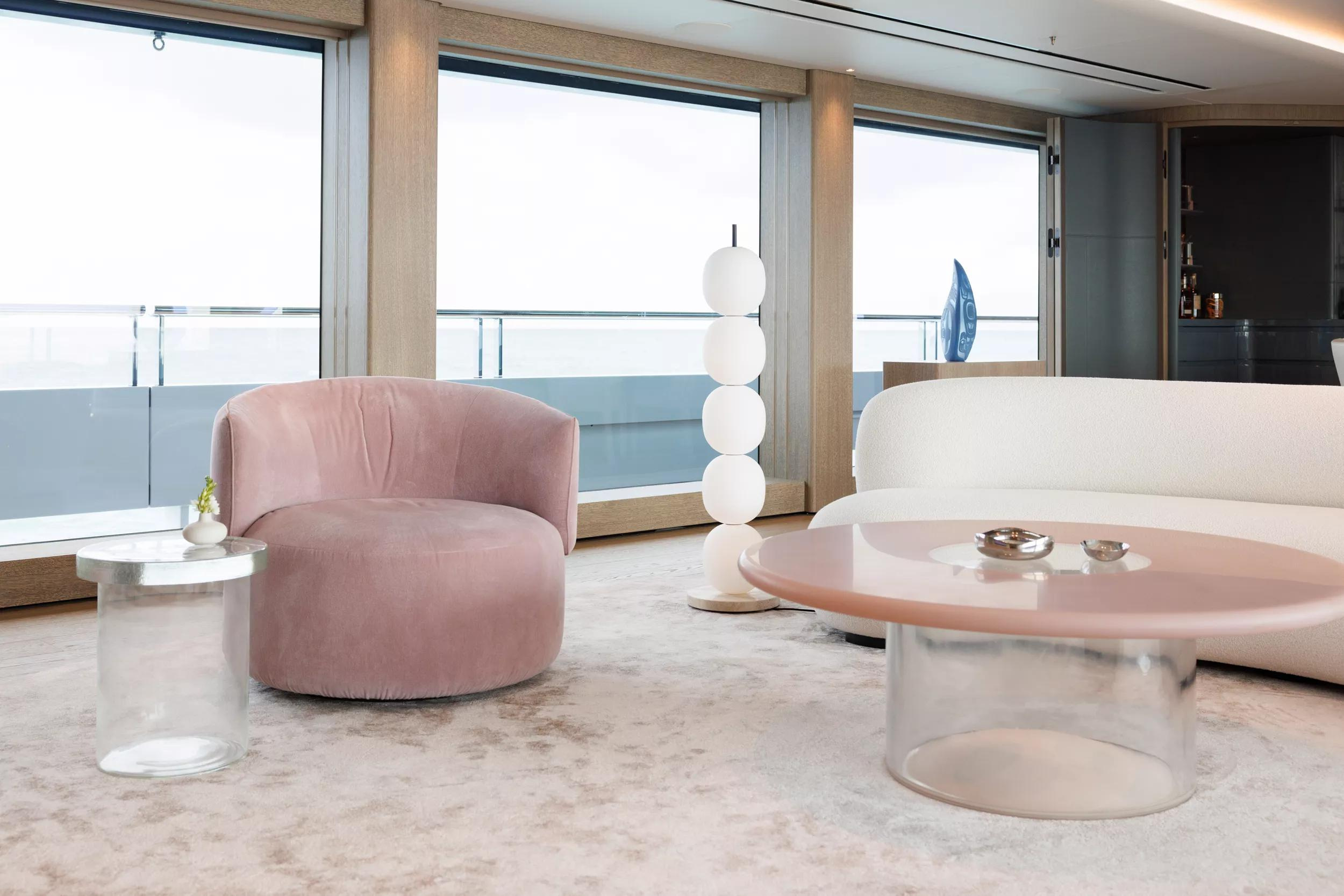 A pink lounge chair and curved table in the Burdifilek interior illustrated for ENTOURAGE.