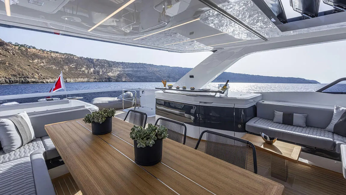 Dining and seating beneath the Pearl 82 flybridge hardtop in the official gallery.
