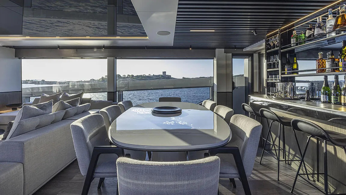 Dining and reflective joinery in the same Indulgence interior presentation.