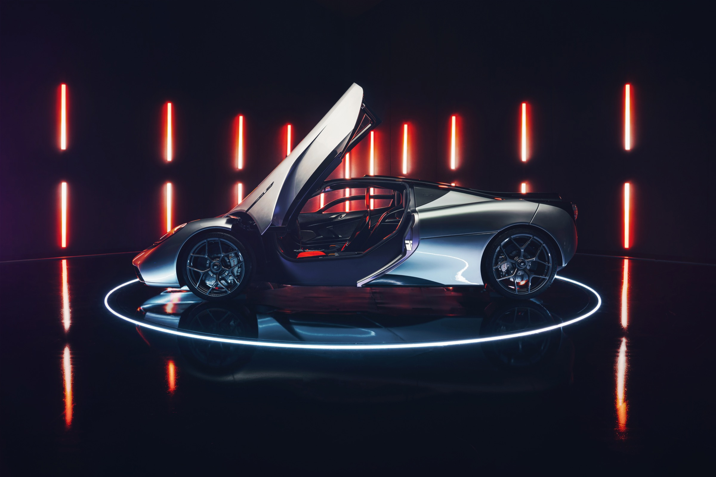The raised door exposes the central seat within the T.50 side profile.