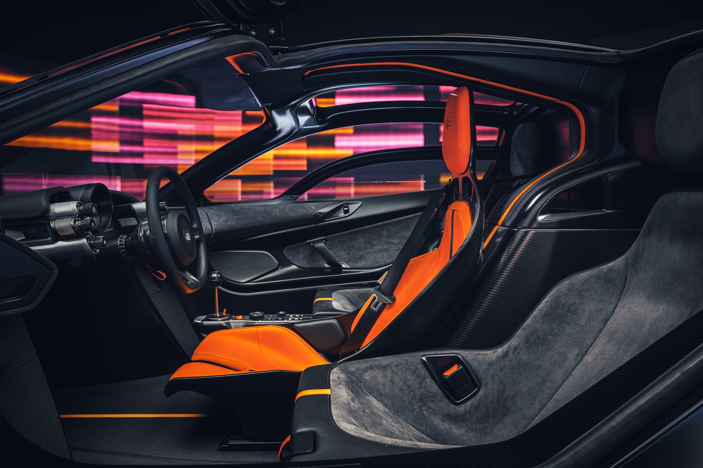 The central orange driving seat and the two supporting passenger positions.