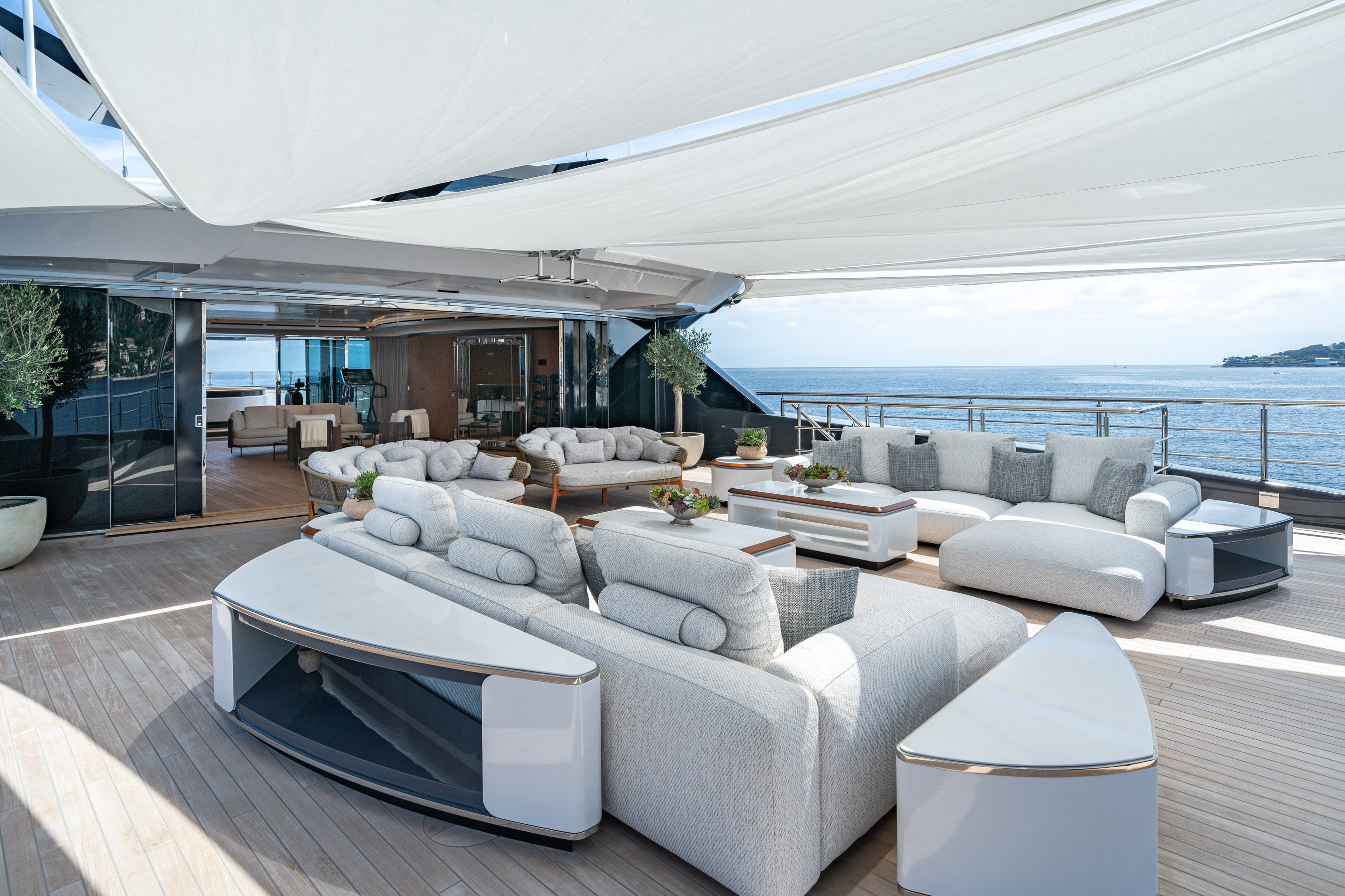 A sheltered sun-deck lounge aboard MALIA, with separate seating groups.
