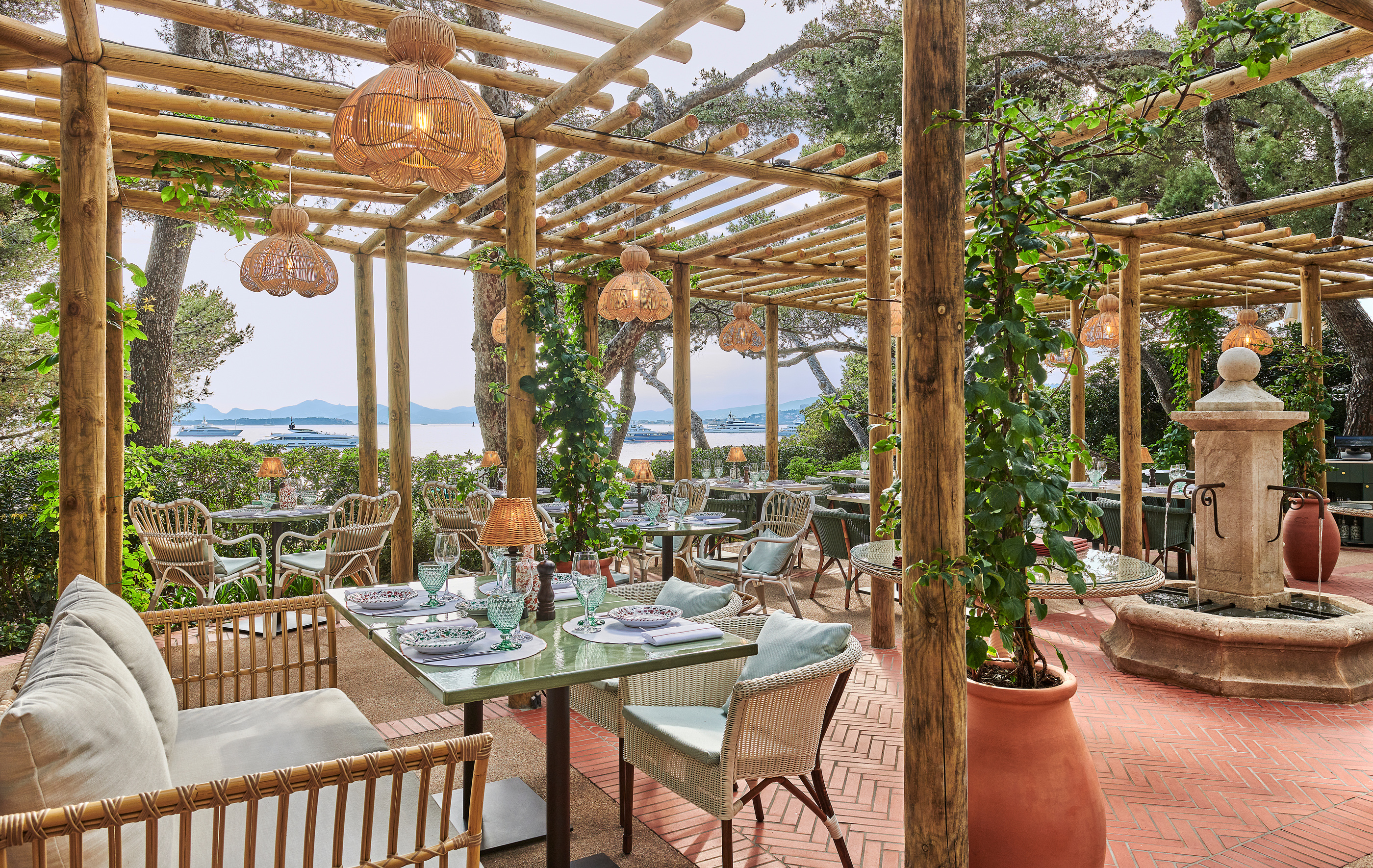 The shaded outdoor dining setting of Giovanni’s within the hotel grounds.