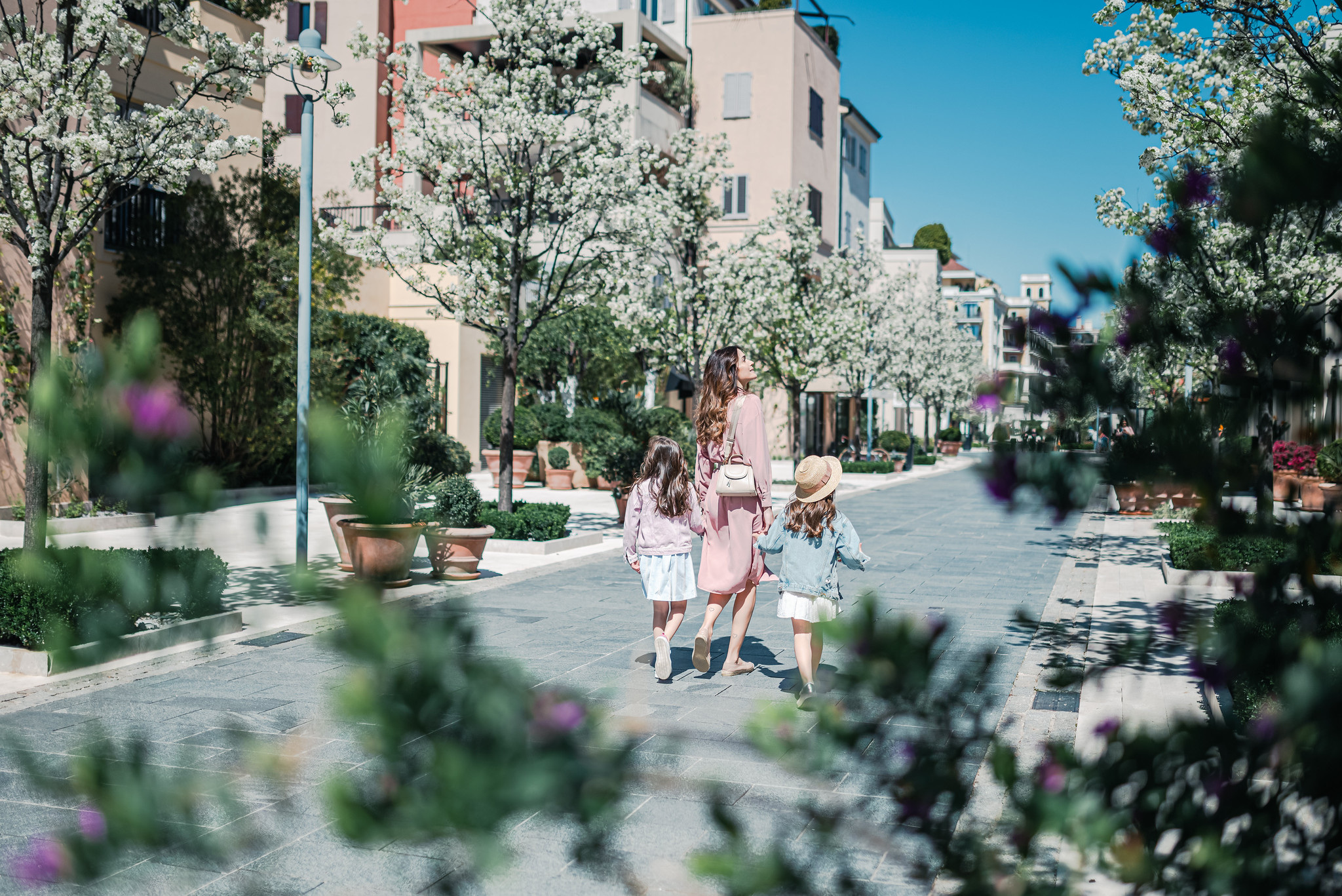 Planting and building fronts give one of the village’s pedestrian settings a smaller scale.
