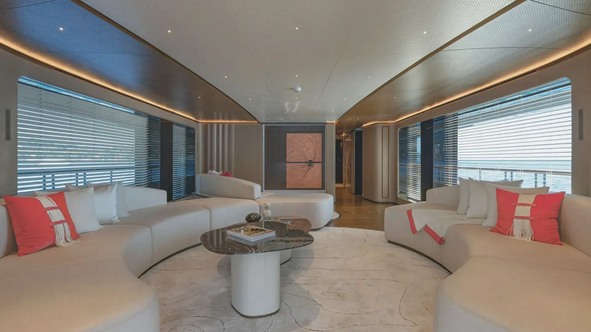 Reverse view of the Sirena 42M saloon, showing curved upholstery and ceiling lighting.