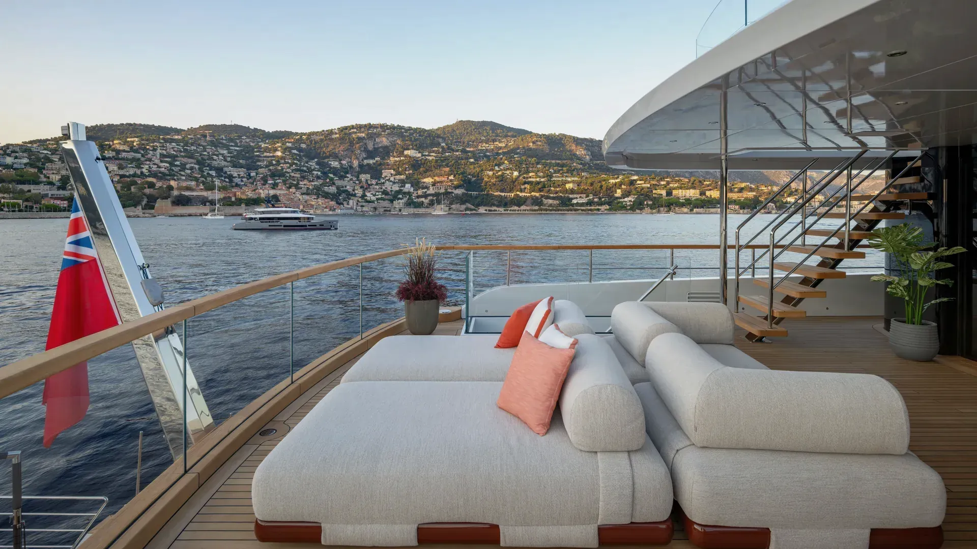 The Sirena 42M upper aft lounge with freestanding sofas and views along the coast.