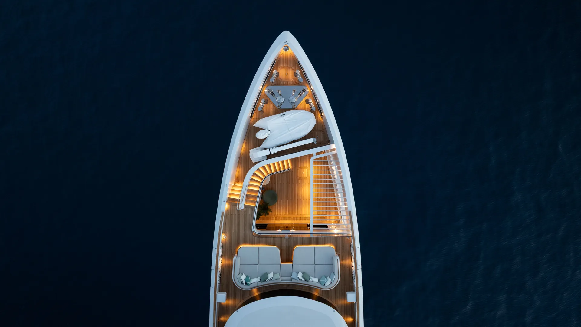 Top-down photograph of the Sirena 42M bow at night, showing the pergola and illuminated deck.